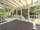 Covered deck with white railing overlooking green backyard at 4636 Brown Creek Church Rd, Wadesboro, NC 28170