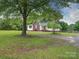 Traditional home with a brick accent, surrounded by mature trees, offering a serene and spacious outdoor area at 4636 Brown Creek Church Rd, Wadesboro, NC 28170