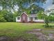 Inviting home featuring a brick facade, complemented by a well-kept lawn and mature landscaping at 4636 Brown Creek Church Rd, Wadesboro, NC 28170