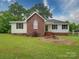 Charming single-story home featuring a brick facade, a well-manicured lawn, and lush landscaping at 4636 Brown Creek Church Rd, Wadesboro, NC 28170