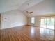 Bright living room featuring vaulted ceiling, wood-look flooring, and sliding glass doors to deck at 4636 Brown Creek Church Rd, Wadesboro, NC 28170