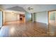 Open floor plan with wood-look flooring connecting living room to kitchen area at 4636 Brown Creek Church Rd, Wadesboro, NC 28170