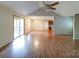 Open floor plan living room with vaulted ceilings, wood-look flooring, and access to the deck at 4636 Brown Creek Church Rd, Wadesboro, NC 28170