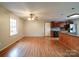 Spacious room showing the kitchen, hardwood floors, and an open floor plan layout at 4636 Brown Creek Church Rd, Wadesboro, NC 28170