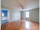 Spacious main bedroom with wood-look flooring, ceiling fan, and ensuite bathroom at 4636 Brown Creek Church Rd, Wadesboro, NC 28170