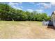 The large grass-filled backyard has privacy trees along the back at 4750 Enochville Rd, Kannapolis, NC 28081