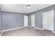 Spacious bedroom with light gray walls, gray flooring, and white doors at 4750 Enochville Rd, Kannapolis, NC 28081