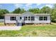 A charming single-story house with gray siding and contrasting dark shutters and stairs at 4750 Enochville Rd, Kannapolis, NC 28081
