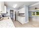 Bright kitchen featuring stainless steel appliances, granite counters, and light gray flooring at 4750 Enochville Rd, Kannapolis, NC 28081