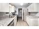 Well-lit kitchen with stainless appliances, granite counters, and white cabinets at 4750 Enochville Rd, Kannapolis, NC 28081