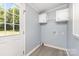 This laundry room is bright with a back door and storage cabinets at 4750 Enochville Rd, Kannapolis, NC 28081