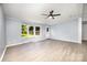 Bright living room features a ceiling fan, bay window, and light gray flooring at 4750 Enochville Rd, Kannapolis, NC 28081