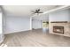 Bright living room with a modern fireplace, ceiling fan, and seamless flow to the outdoor patio at 4750 Enochville Rd, Kannapolis, NC 28081