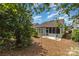 Backyard featuring a patio with chairs and a glimpse of the screened-in porch, surrounded by greenery at 5141 Grandview Dr, Fort Mill, SC 29707