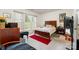 Bright bedroom with a large window, wood furniture, and a red accent rug at 5141 Grandview Dr, Fort Mill, SC 29707