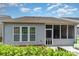 View of the home's exterior, including the screen porch, windows, and a well-maintained yard at 5141 Grandview Dr, Fort Mill, SC 29707