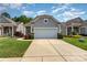 Charming single-story home boasts a two-car garage, manicured lawn, and inviting curb appeal at 5141 Grandview Dr, Fort Mill, SC 29707