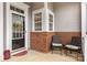 Inviting front porch featuring brick accents, a glass door, and outdoor seating at 5141 Grandview Dr, Fort Mill, SC 29707