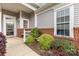 Charming front porch with brick accents, stylish door, and landscaped garden beds at 5141 Grandview Dr, Fort Mill, SC 29707