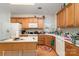 Well-lit kitchen with white countertops, wood cabinets and modern appliances at 5141 Grandview Dr, Fort Mill, SC 29707