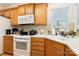 Well-lit kitchen with white countertops and ample wood cabinet space at 5141 Grandview Dr, Fort Mill, SC 29707
