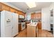 Well-lit kitchen with wooden cabinets, white appliances, and hardwood flooring at 5141 Grandview Dr, Fort Mill, SC 29707