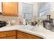 Close-up of a kitchen sink with a faucet, window with blinds, and light countertops at 5141 Grandview Dr, Fort Mill, SC 29707