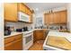 Efficient kitchen featuring wood cabinets, and modern appliances including a white range at 5141 Grandview Dr, Fort Mill, SC 29707