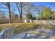 The spacious backyard features a wooden deck, lush lawn, mature trees, and convenient storage sheds at 532 Scaleybark Rd, Charlotte, NC 28209