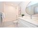 Bathroom featuring a tub/shower combo, white vanity, and a round mirror at 532 Scaleybark Rd, Charlotte, NC 28209