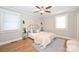 Comfortable bedroom with hardwood floors, a ceiling fan, neutral paint, and bright natural light at 532 Scaleybark Rd, Charlotte, NC 28209