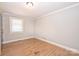 Bedroom with hardwood floors, neutral paint, and bright natural light at 532 Scaleybark Rd, Charlotte, NC 28209