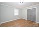 Bedroom featuring hardwood floors, closet, neutral paint, and natural light at 532 Scaleybark Rd, Charlotte, NC 28209