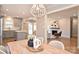 Open dining room with a view to a new kitchen and a living room with a fireplace and modern design at 532 Scaleybark Rd, Charlotte, NC 28209