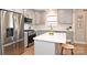 Modern kitchen featuring stainless steel appliances, light grey cabinets, quartz countertops, and a cozy island at 532 Scaleybark Rd, Charlotte, NC 28209