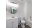 Bathroom featuring a round mirror, modern flooring, and neutral paint at 5343 Esther Ln, Charlotte, NC 28214