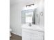 Clean bathroom featuring a white vanity, a large mirror, and modern lighting at 5343 Esther Ln, Charlotte, NC 28214