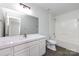 Well-lit bathroom featuring a large vanity, toilet, and bathtub with shower at 5343 Esther Ln, Charlotte, NC 28214