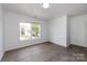 Bedroom with a large window, modern flooring, and neutral paint at 5343 Esther Ln, Charlotte, NC 28214