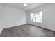 Bright bedroom with a large window, hardwood floors, and neutral paint at 5343 Esther Ln, Charlotte, NC 28214