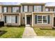 Charming townhome featuring a well-maintained front yard, tan siding, and dark blue shutters at 5343 Esther Ln, Charlotte, NC 28214