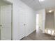 Bright hallway with modern flooring, white doors, and access to various rooms at 5343 Esther Ln, Charlotte, NC 28214