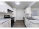 Well-lit kitchen featuring white cabinetry, updated appliances, and sleek countertops at 5343 Esther Ln, Charlotte, NC 28214