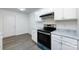 Updated kitchen with white cabinets, a modern range, and sleek countertops at 5343 Esther Ln, Charlotte, NC 28214
