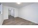 Spacious room featuring sleek floors, neutral walls, and a view into the entrance at 5343 Esther Ln, Charlotte, NC 28214