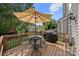 Back deck with grill, umbrella, and dining table provides an outdoor dining and entertainment space at 5428 Colonial Garden Dr, Huntersville, NC 28078