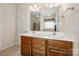 Bright bathroom featuring a double sink vanity, large mirror, tiled floors, and a separate shower area at 5428 Colonial Garden Dr, Huntersville, NC 28078