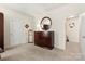 Bright bedroom features a dresser, round mirror, neutral walls, and carpeted floors, creating a peaceful retreat at 5428 Colonial Garden Dr, Huntersville, NC 28078