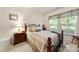 Inviting bedroom features a decorative iron bed frame, neutral bedding, and natural light from two windows at 5428 Colonial Garden Dr, Huntersville, NC 28078
