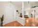 Bright foyer featuring hardwood floors, an entry door, a dining space, and classic architectural details at 5428 Colonial Garden Dr, Huntersville, NC 28078